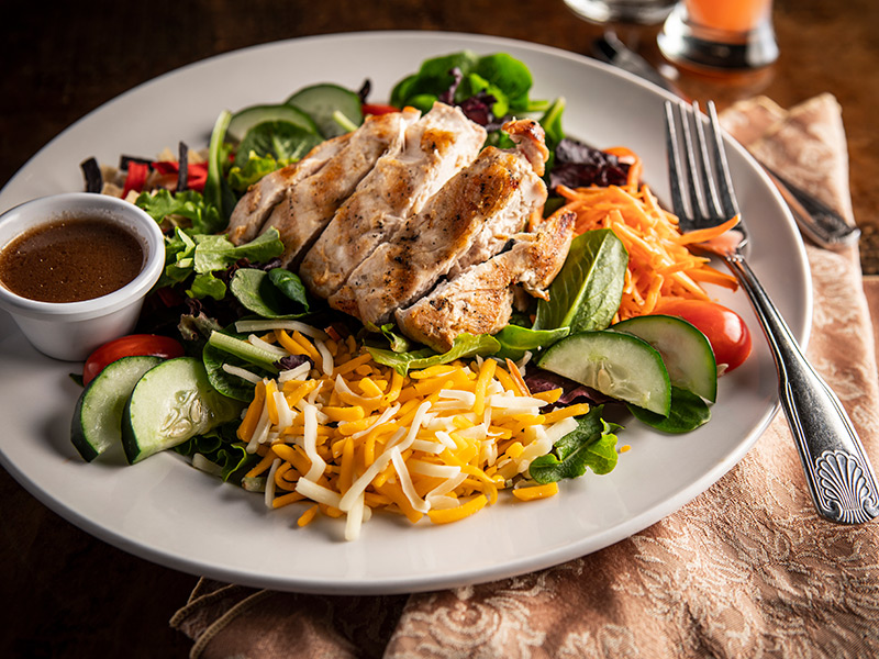 Plate of food with grilled chicken salad